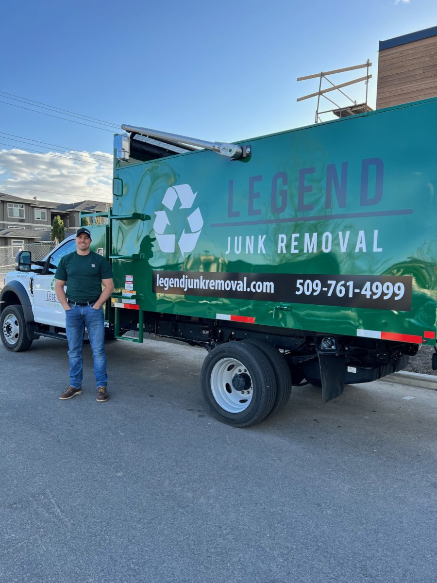 legend junk removal truck and owner standing in front of it