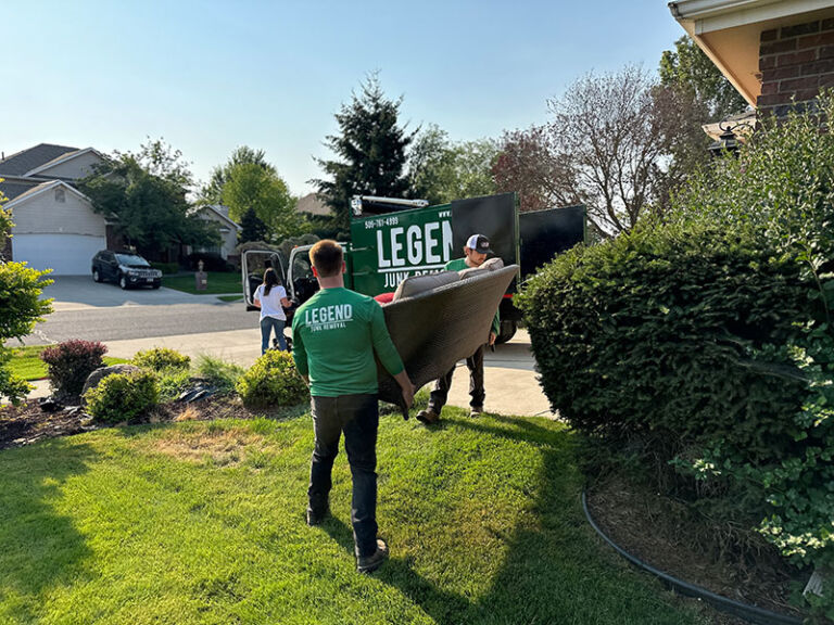 Legend Junk Removal team loading old sofa to the junk truck