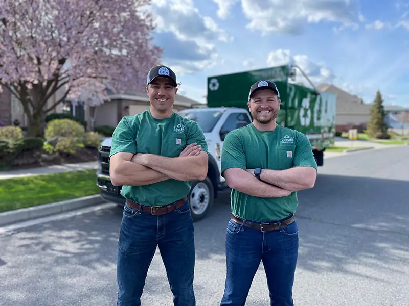 Legend Junk Removal crew posing outside Spokane customer home