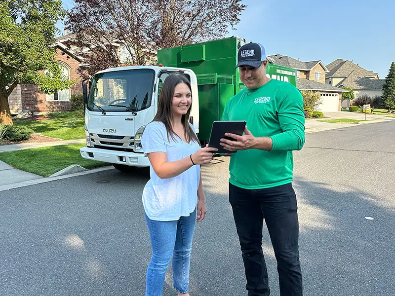 Legend Junk Removal crew discussing junk removal terms to the customer